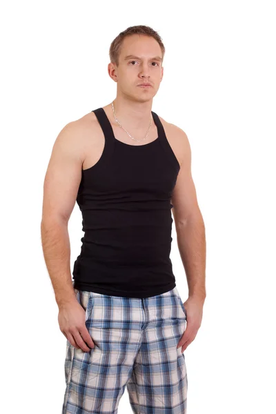 Young man in plaid shorts and tank top. Studio shot over white. — Stock Photo, Image