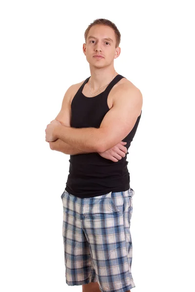 Young man in plaid shorts and tank top. Studio shot over white. — Zdjęcie stockowe