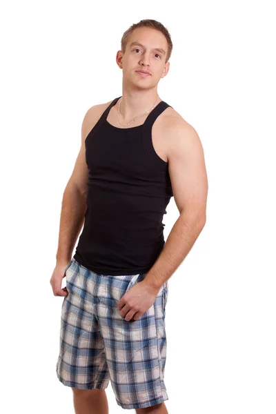 Jonge man in korte geruite broek en tank top. studio opname over Wit. — Stockfoto