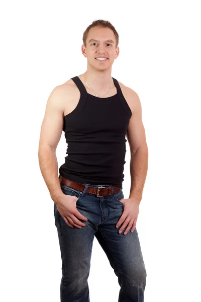 Man in jeans en zwart onderhemdje. studio opname over Wit. — Stockfoto