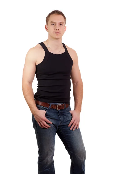 Man in jeans and black undershirt. Studio shot over white. — Stock Photo, Image