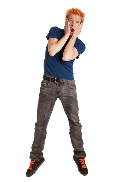 Genç adam mavi tişört ve kot pantolon. Beyaz ateş studio. — Stok fotoğraf