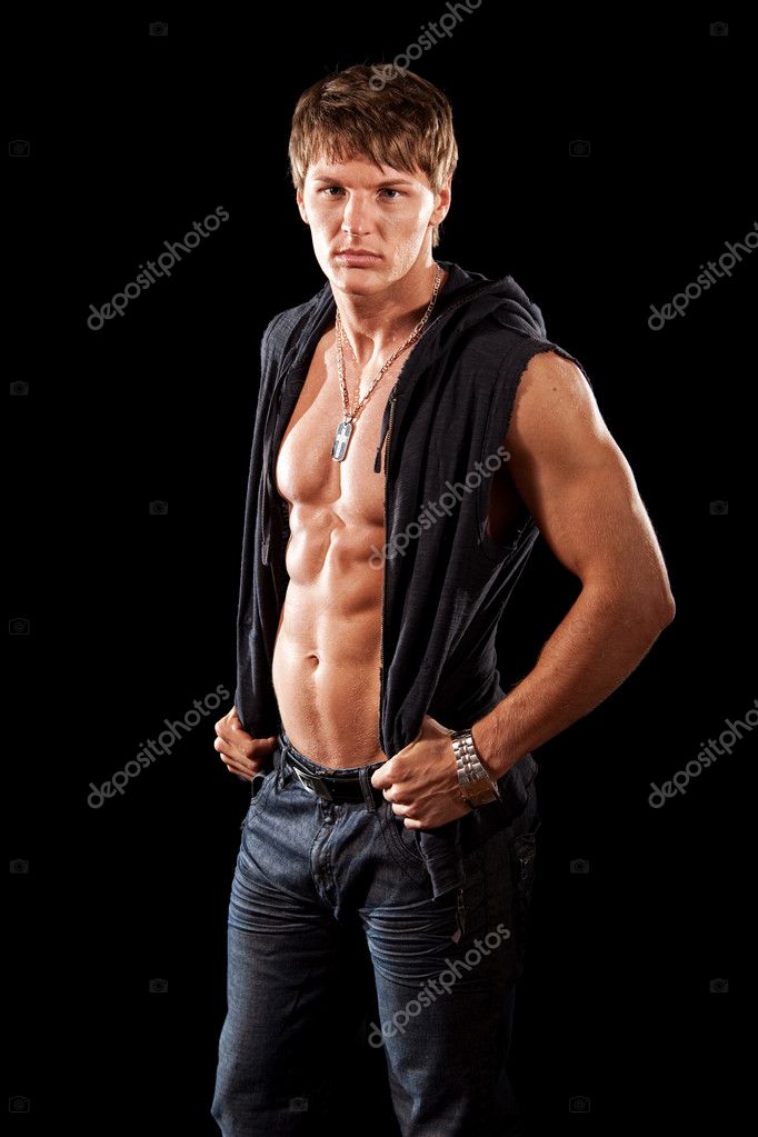 Bodybuilder in jeans with shirt open. Studio shot over black. — Stock Photo © nickp37 6528211