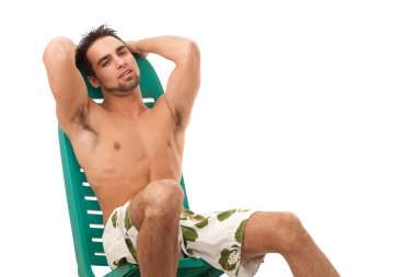 Attractive young man in boardshorts. Studio shot over white. clipart