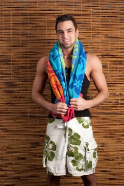 Attractive young man in boardshorts. Studio shot. clipart