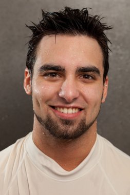 Headshot on a young man. Wet look with grey background. clipart