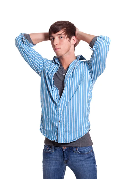 Молодой человек в синих джинсах и рубашке. Студия над белым . — стоковое фото