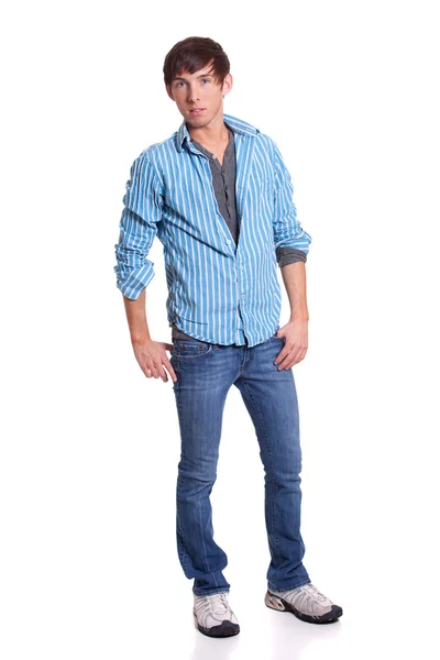 Młody człowiek w niebieskie dżinsy i koszulę. łapka na biały. — Zdjęcie stockowe