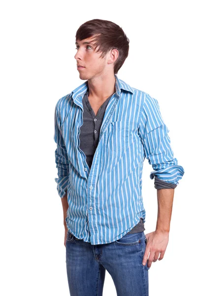 Jonge man in blauwe jeans en shirt. studio opname over Wit. — Stockfoto