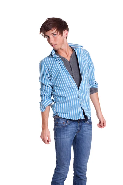Молодой человек в синих джинсах и рубашке. Студия над белым . — стоковое фото