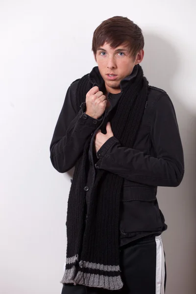 Young man modeling a winter coat. Studio shot. — Stock Photo, Image