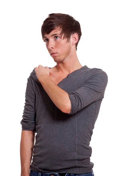 Junger Mann im grauen Hemd. Studioaufnahme über Weiß. — Stockfoto