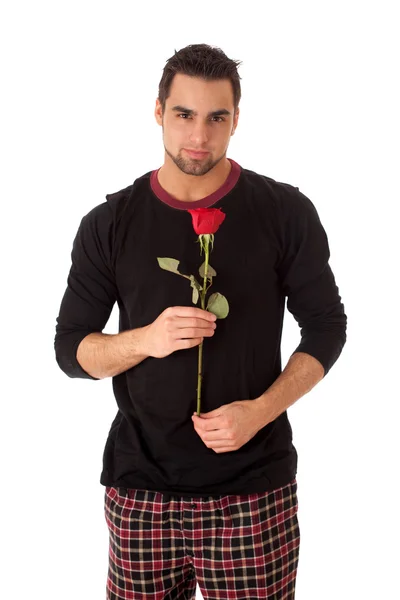 Uomo attraente in pigiama con una sola rosa rossa . — Foto Stock