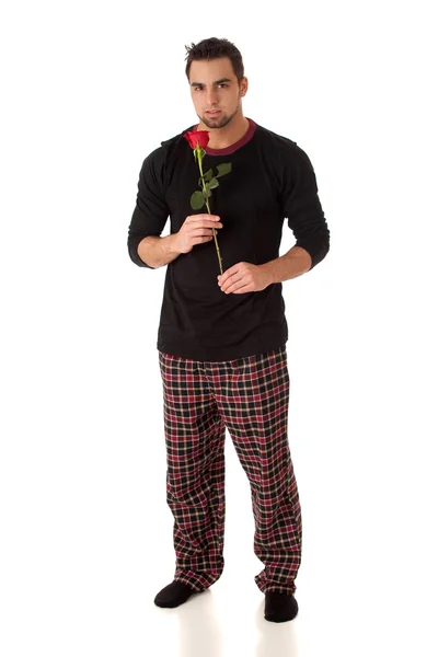 Uomo attraente in pigiama con una sola rosa rossa . — Foto Stock
