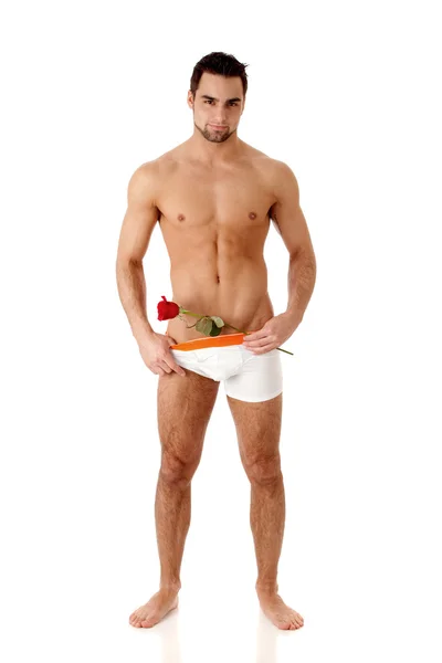 Mężczyzna atrakcyjny w bielizna z jedną czerwoną różą. — Zdjęcie stockowe