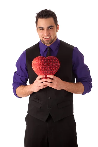 Well dressed young man with a heart-shaped box. — Stock Photo, Image