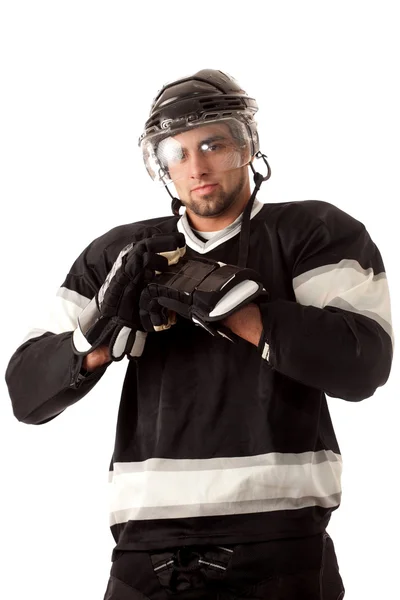 Ice hockey player dressing. Studio shot over white. — Stock Photo, Image