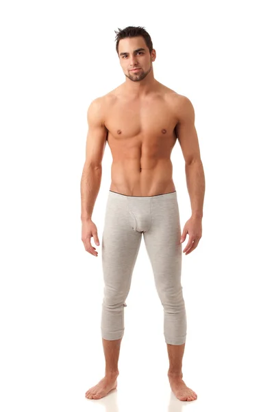 Aantrekkelijke man in lange ondergoed. studio opname over Wit. — Stockfoto