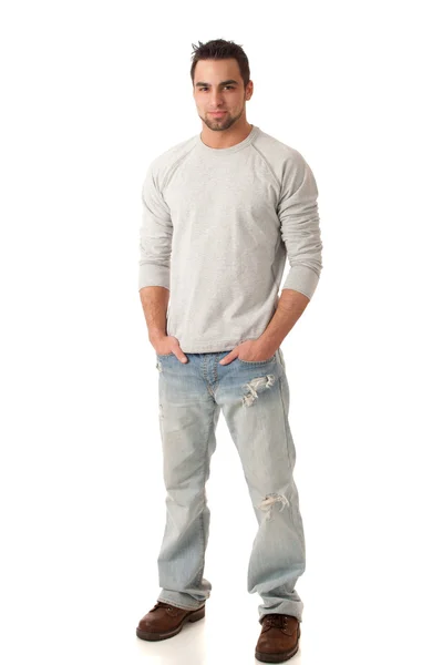 Jonge man in jeans en trui. studio opname over Wit. — Stockfoto
