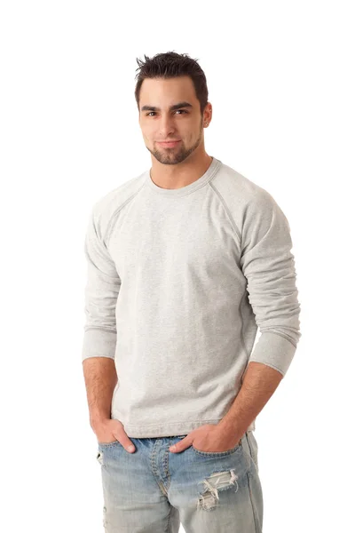Młody człowiek w sweter i dżinsy. łapka na biały. — Zdjęcie stockowe