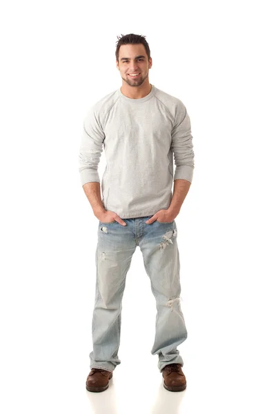 Młody człowiek w sweter i dżinsy. łapka na biały. — Zdjęcie stockowe