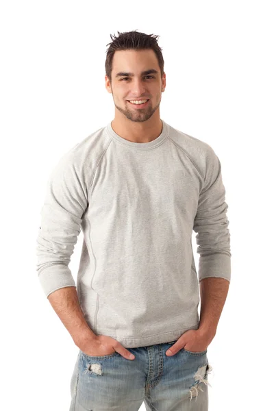 Молодий чоловік в джинсах і светрі. Студійний знімок над білим . — стокове фото