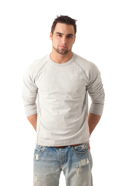 Junger Mann in Jeans und Pullover. Studioaufnahme über Weiß. — Stockfoto