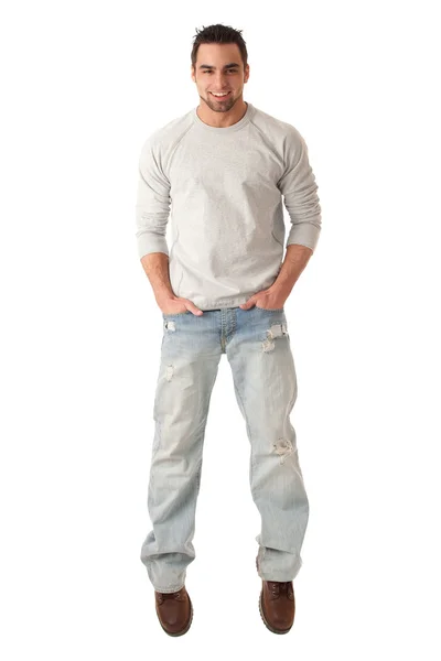 Mladý muž v džínách a svetr. Studio zastřelil bílá. — Stock fotografie