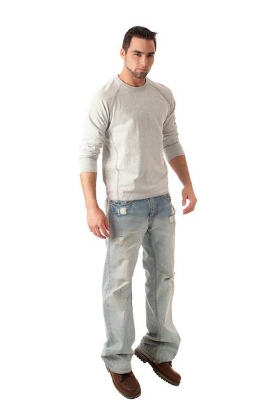 Jonge man in jeans en trui. studio opname over Wit. — Stockfoto