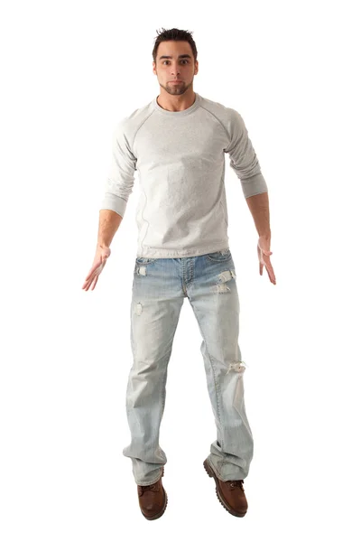 Junger Mann in Jeans und Pullover. Studioaufnahme über Weiß. — Stockfoto