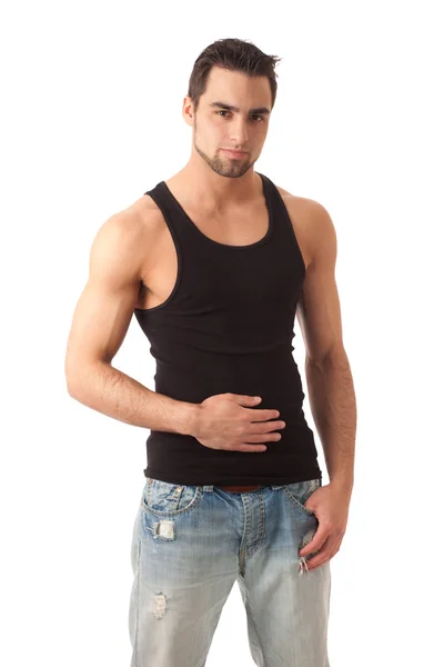 Jonge man in jeans en zwart onderhemdje. studio opname over Wit. — Stockfoto