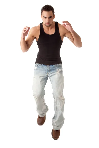 若い男のジーンズと黒のアンダーシャツに。白にわたって撮影スタジオ. — ストック写真