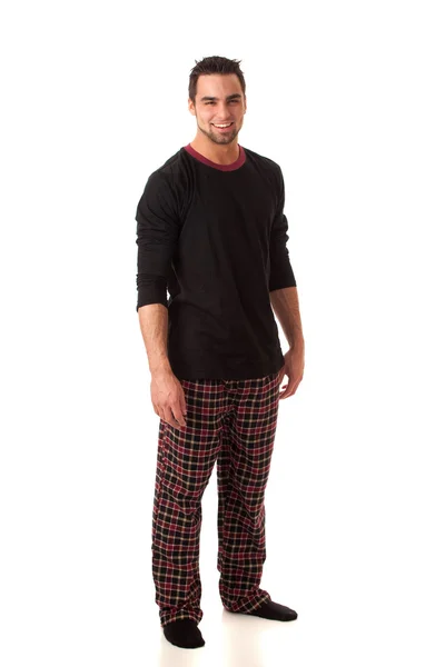 Aantrekkelijke man in pyjama. studio opname over Wit. — Stockfoto