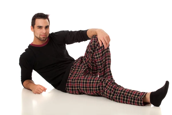 Attractive man in pajamas. Studio shot over white. — Stock Photo, Image