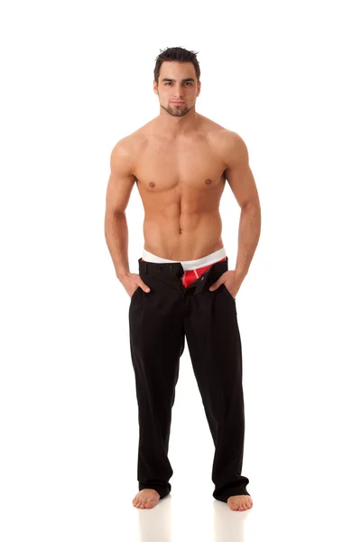 Attraktiver Mann mit Hose ohne Reißverschluss und roter Unterwäsche. Studio angezündet — Stockfoto
