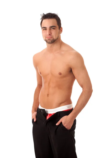 Homem atraente com calças desapertadas, mostrando roupa interior vermelha. Estúdio disparado — Fotografia de Stock