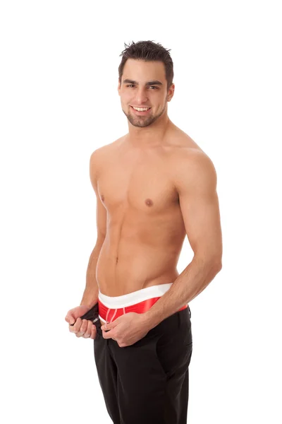 Uomo attraente con i pantaloni senza zip, mostrando biancheria intima rossa. Studio abbattuto — Foto Stock