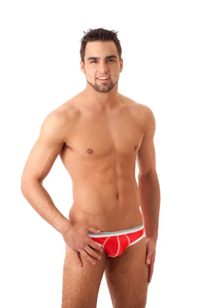 Attraktiver Mann in roter Unterwäsche. Studioaufnahme über Weiß. — Stockfoto