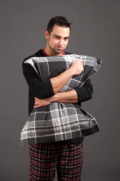 stock image Attractive man in pajamas. Studio shot over grey.