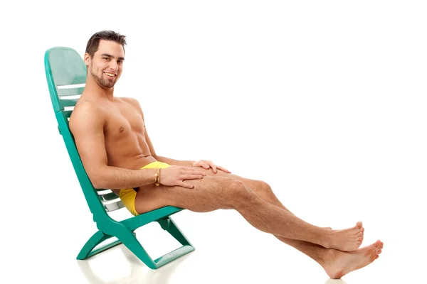 Aantrekkelijke jonge man in zwembroek. studio opname over Wit. — Stockfoto