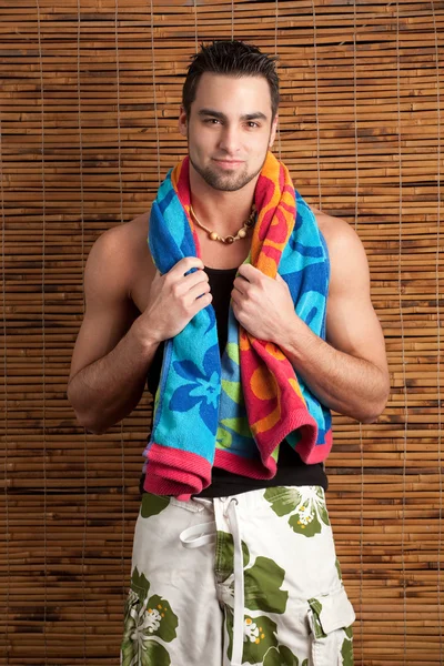 Attractive young man in boardshorts. Studio shot. — Stock Photo, Image