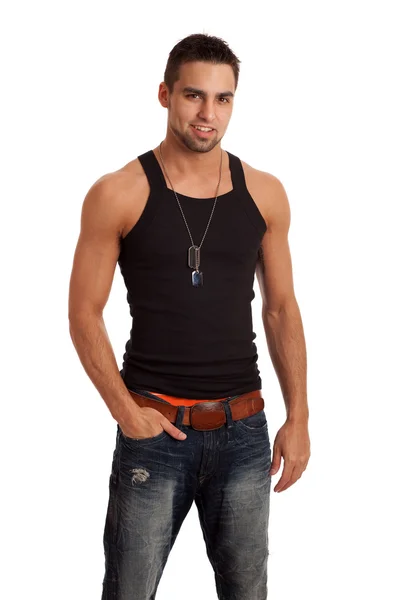 Young man in undershirt and jeans. Studio shot over white. — Stock Photo, Image