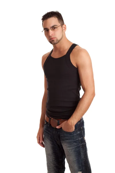 Junger Mann in Unterhemd und Jeans. Studioaufnahme über Weiß. — Stockfoto