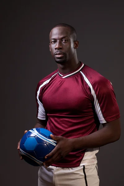 stock image Male soccer player. Studio shot over grey.