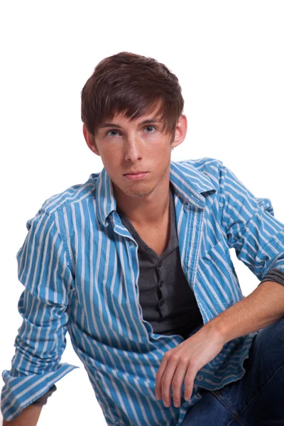 Young man in blue jeans and shirt. Studio shot over white. Stock Photo