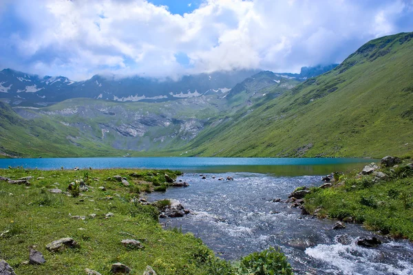 stock image Turquoise mountain lake with river in a summer day