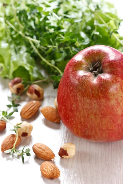 Apple, salad and nuts. — Stock Photo, Image