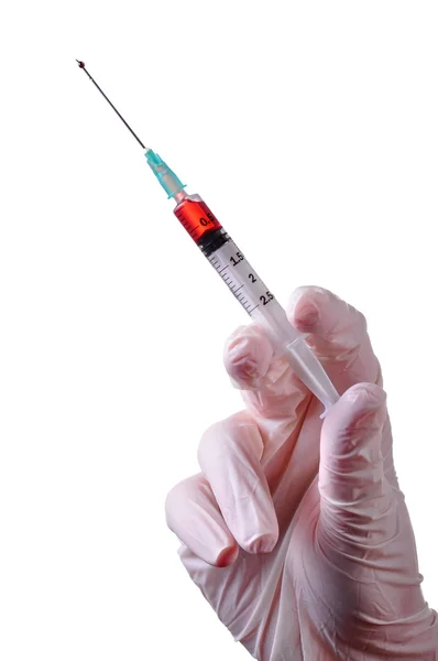 Hand holding a syringe — Stock Photo, Image