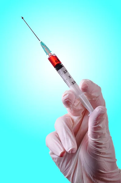 Hand holding a syringe — Stock Photo, Image