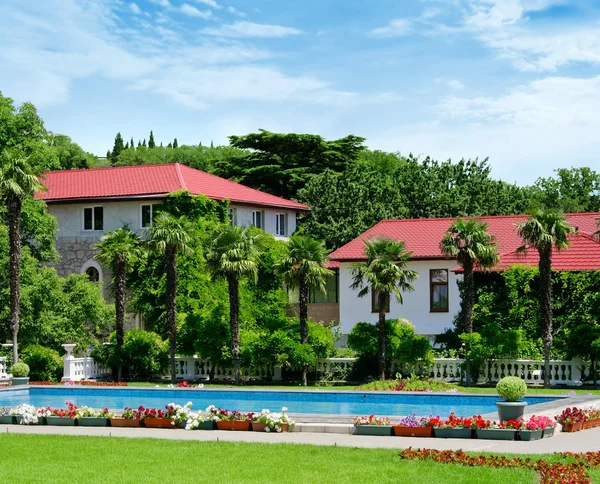 stock image Houses in the green garden with swimming pool